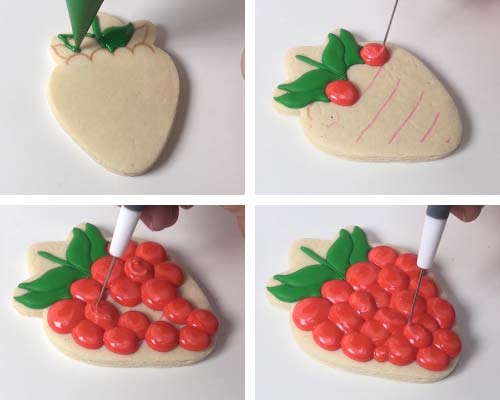 Piping leaves with green royal icing. Piping large dots clustered together with red icing.