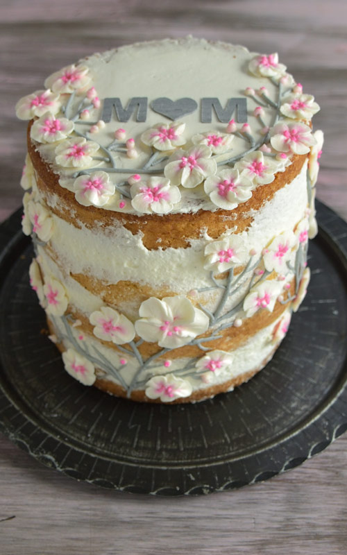 cake decorated with cherry blossom buttercream flowers
