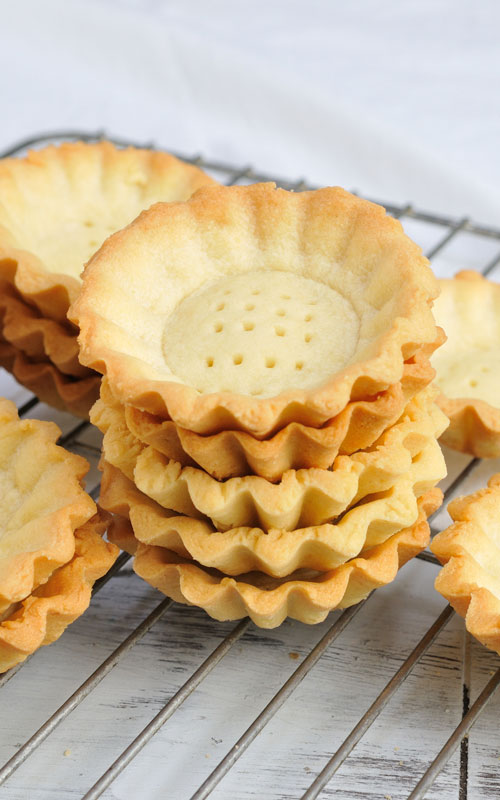 baked mini tart shells with on a cooling rack