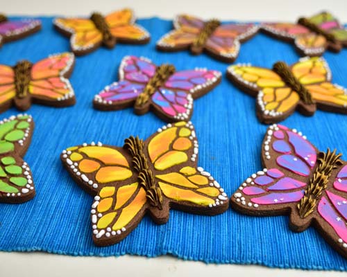 Monarch butterfly cookies on a blue background.