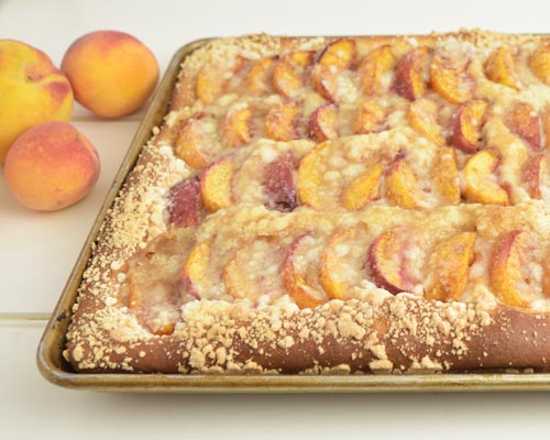 Baked peach slab bread in a baking pan.