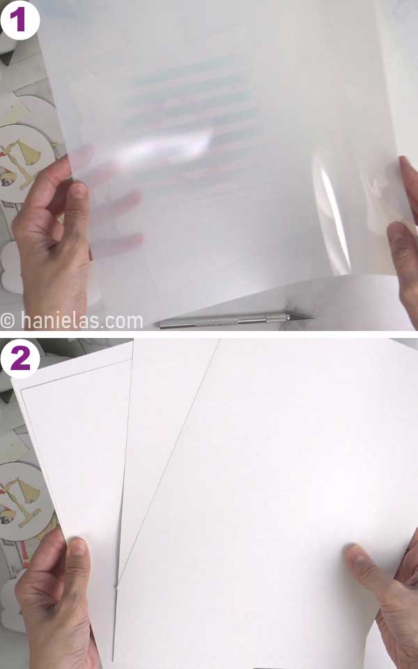 Hands holding cardstock and mylar plastic sheets.