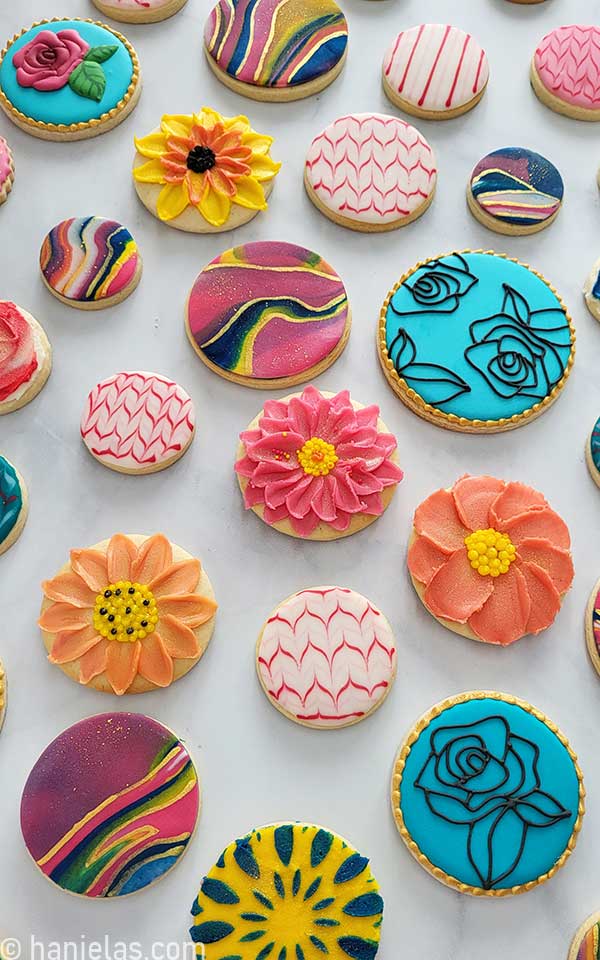 Round cookies decorated with a variety of icings.