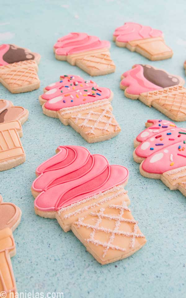 Detail of royal ice cream cone cookie decorated with pink icing.