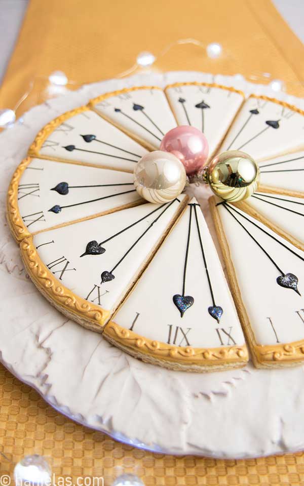 Close up of decorated wedge clock cookies.