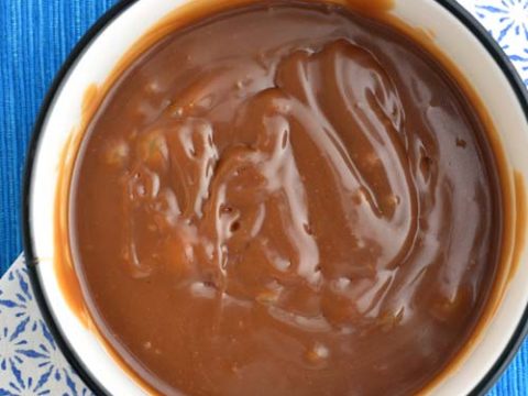 Dark brown caramel sauce in a bowl.