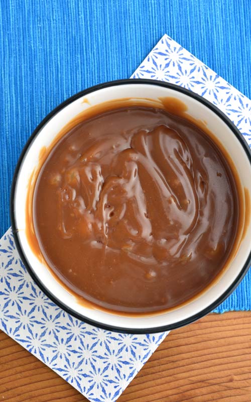 Dark brown caramel sauce in a bowl.