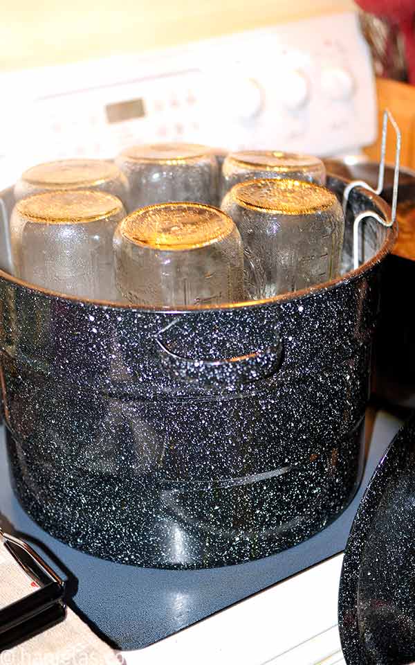 Glass jars in a canning pot.