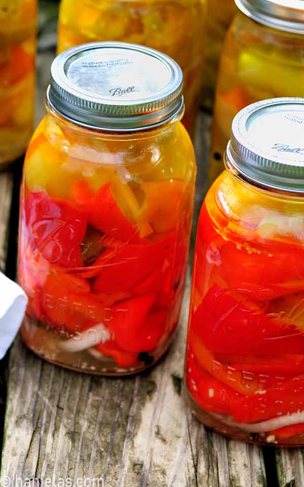 Close up of jars with pickled vegetables.