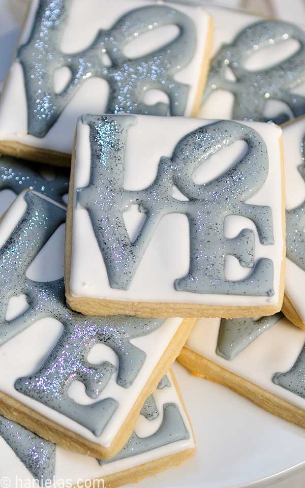 Close-up of a square cookie decorated with royal icing transfer.