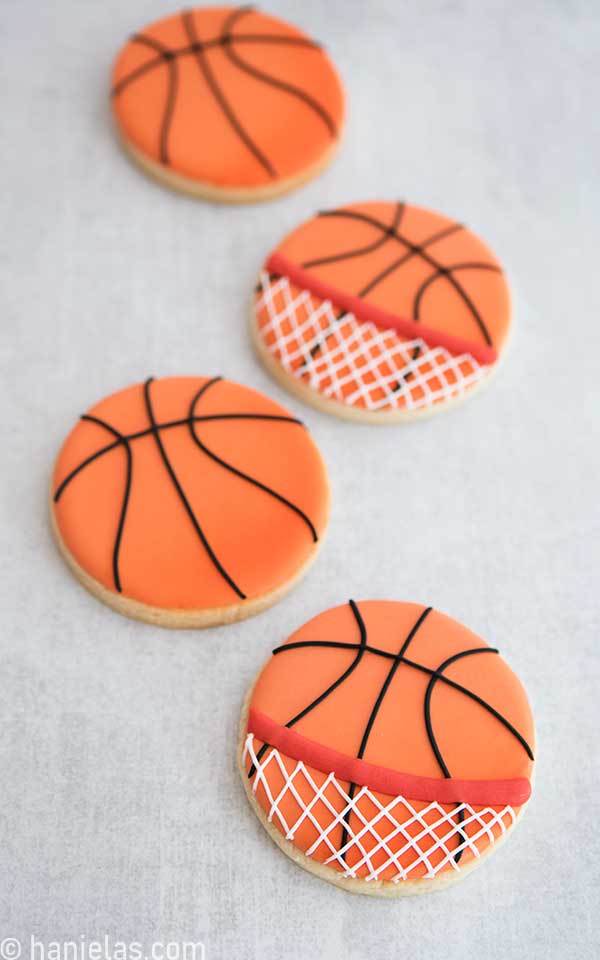 Basketball cookies laid flat on a counter.