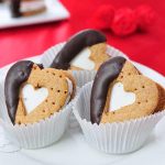 Heart s'mores sandwiches nested in paper liners.