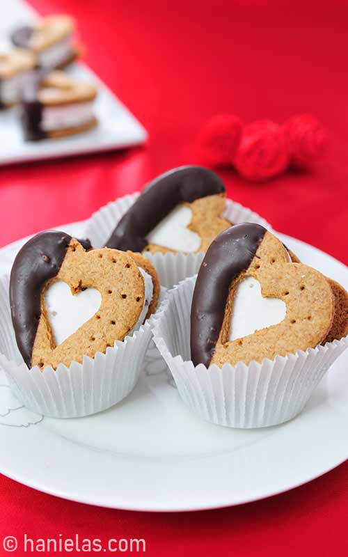 Heart s'mores sandwiches nested in paper liners.