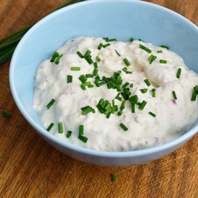 Tartar sauce in a bowl garnished with chopped chives.
