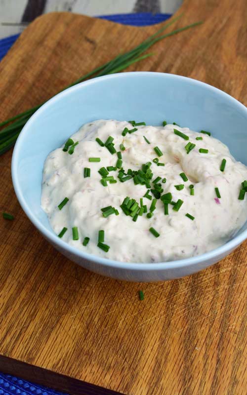 Tartar sauce in a bowl garnished with chopped chives.