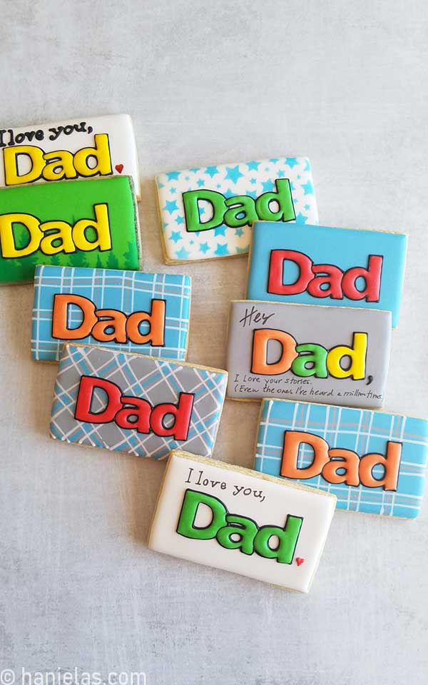 Rectangular cookies decorated with royal icing and dad word.