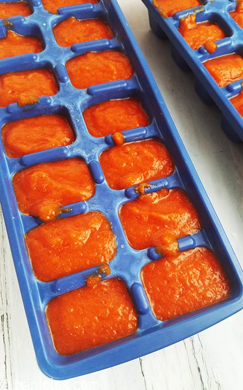 Ice cube tray filled with red pepper puree.