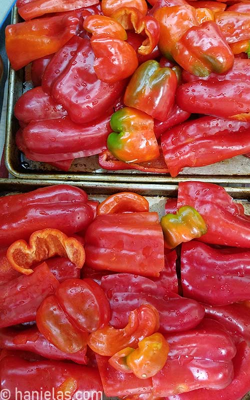 Washed peppers, cut lengthwise layered on a baking sheet.