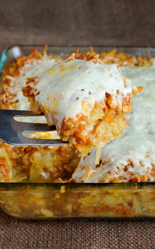 Slice of stuffed cabbage casserole on a metal spatula.