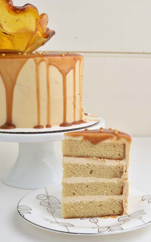 Slice of a cake on a pretty white silver plate.