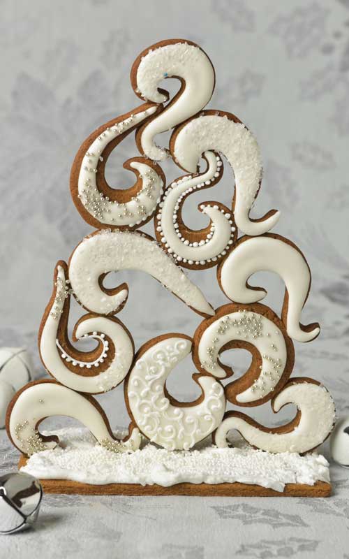 Swirly gingerbread tree centerpiece displayed on a table.