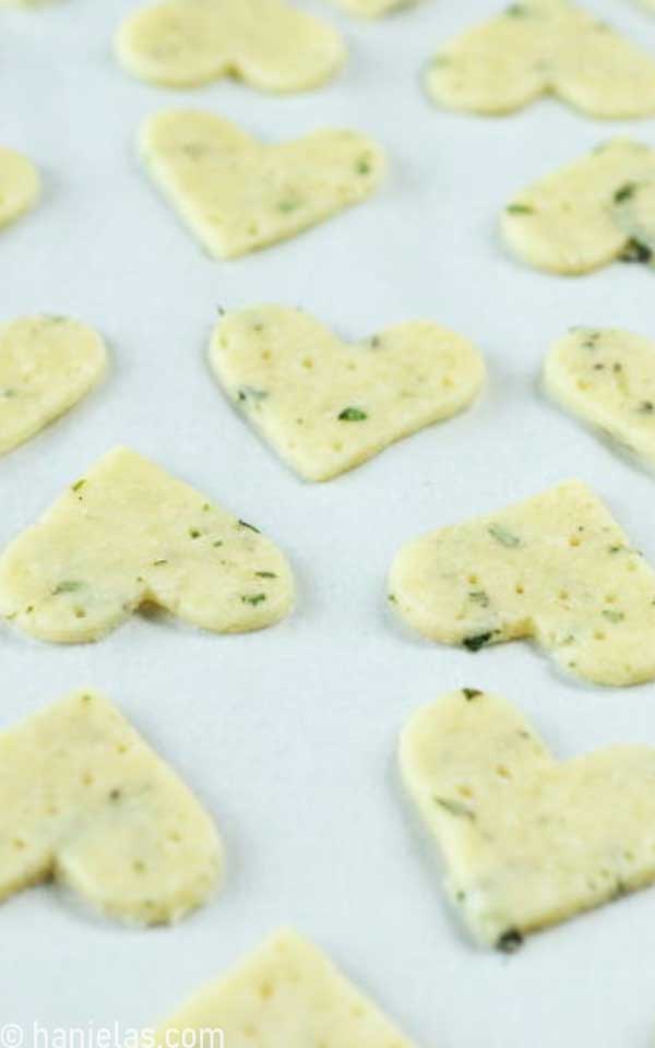 Crackers on a baking sheet lined with parchment.