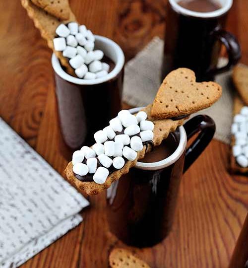 Cookie sticks dipped into hot cocoa.