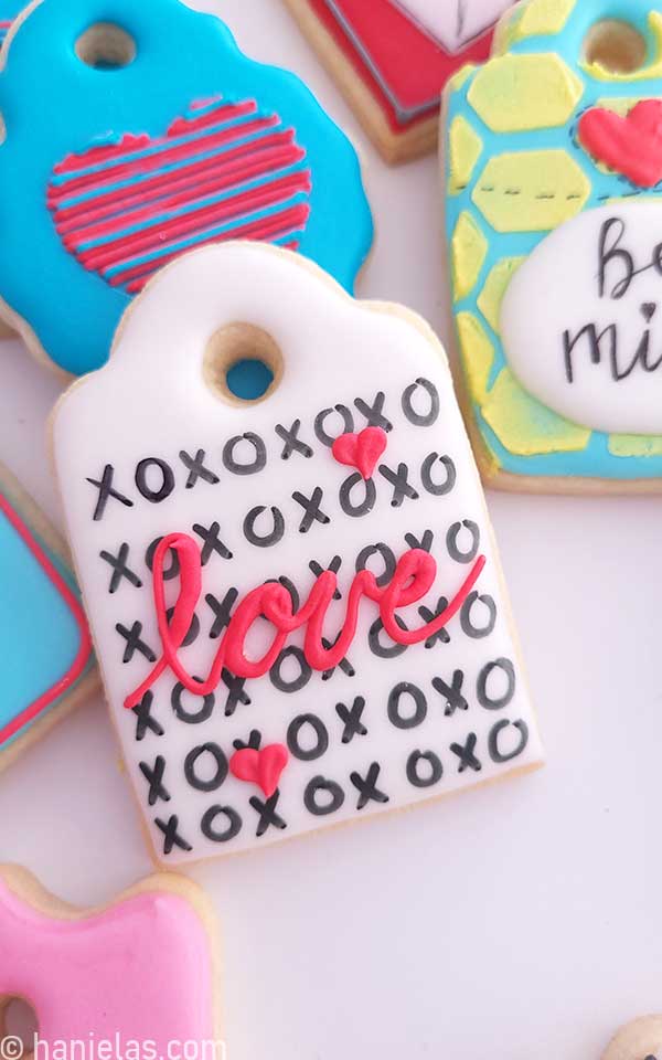 Decorated cookie with written love piped across.