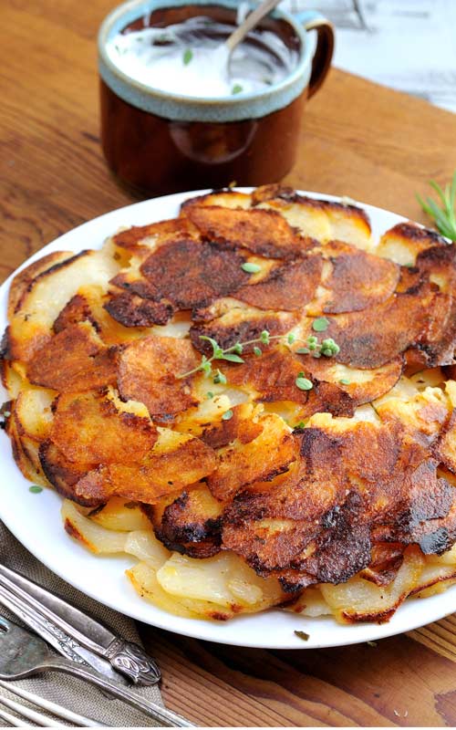 Crispy golden brown potato galette on a plate.