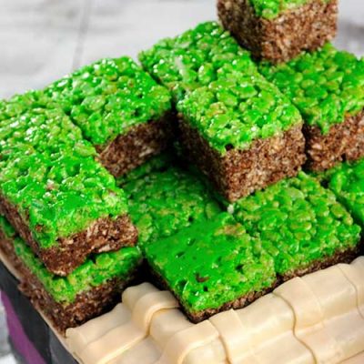 Rice krispie cubes stacked on top of the cake.
