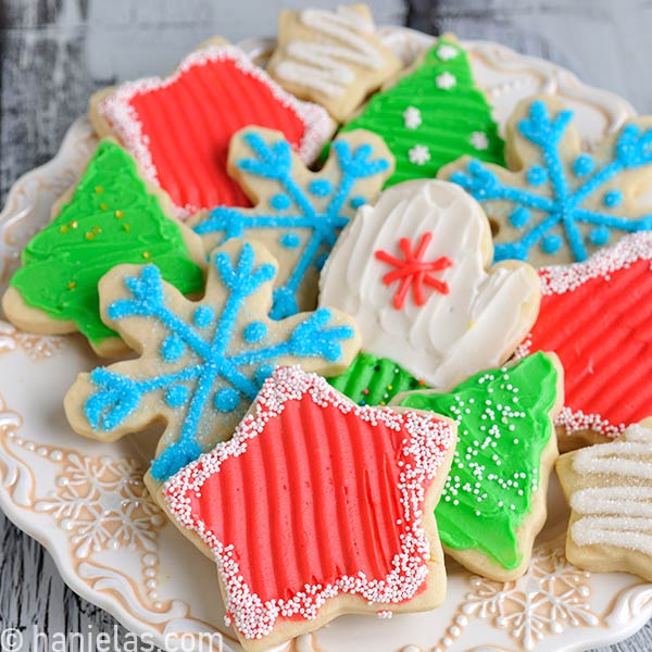 Cookie decorated with buttercream frosting displayed on a pretty festive plate.