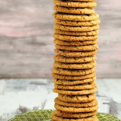 Cookies stacked into a tall tower on a green plate.