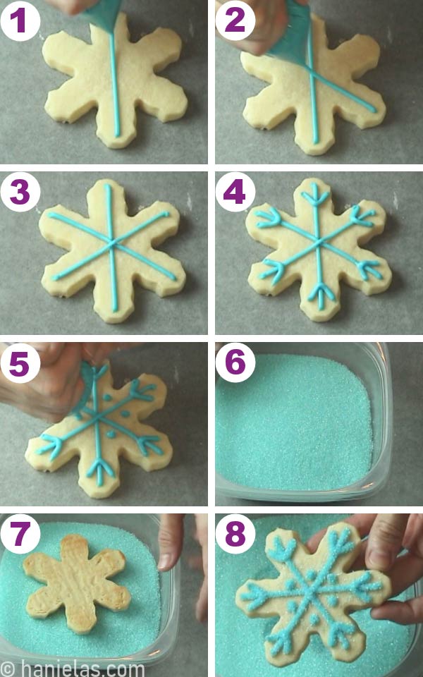 Snowflake cookie with piped blue buttercream designs and dipped in sanding sugar.