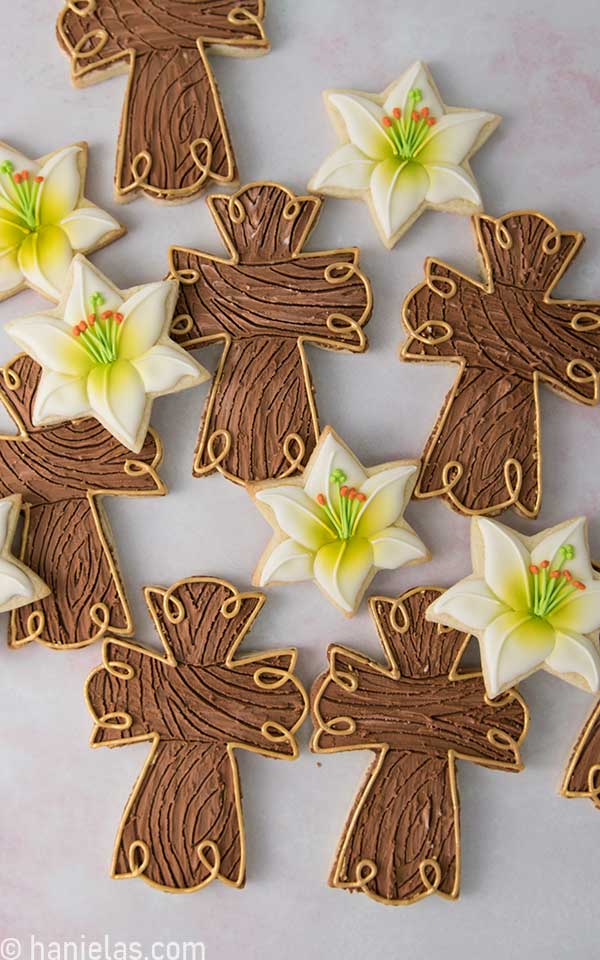 View from the above,  brown cross and lily flower cookies decorated with royal icing.