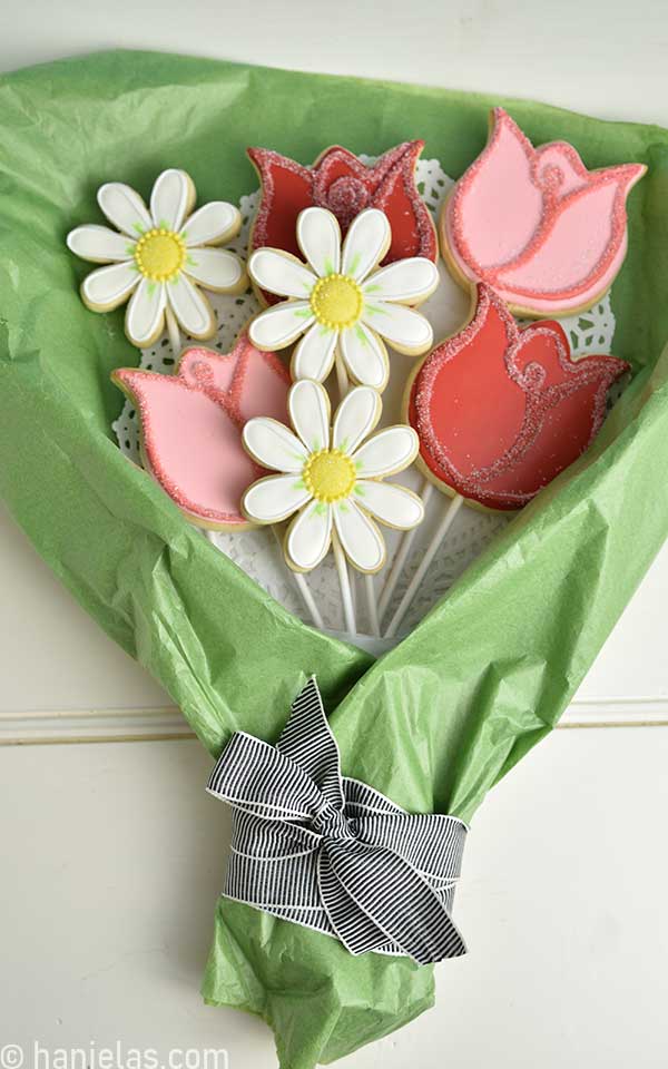 Decorated flower sugar cookies arranged into a flower bouquet.