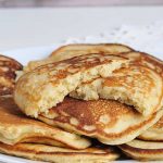 Cooked pancakes stacked on a plate.