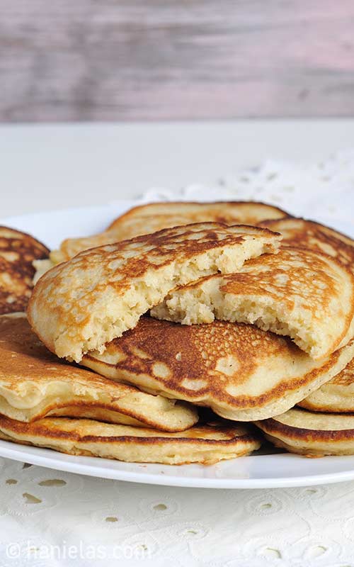 Cooked pancakes stacked on a plate.