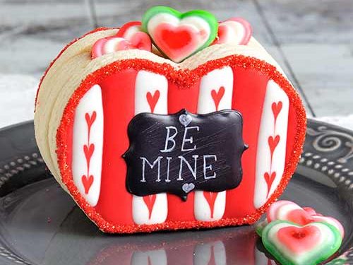 Heart cookie box filled with gummy candies.