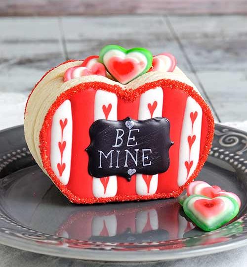 Heart cookie box filled with gummy candies.