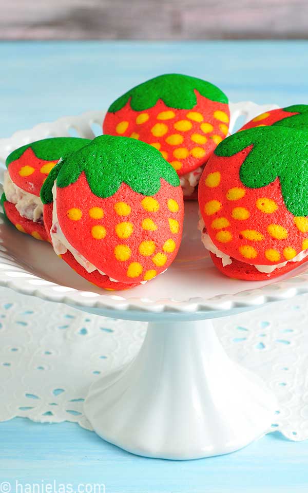 Whoopie pies displayed on a white cake stand.