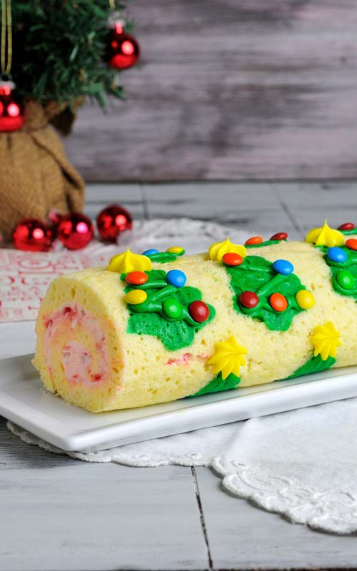 Decorated cake displayed on a white tray showing the side of the cake.