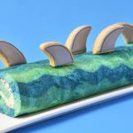 Cake roll with shark fin cookies decorations.