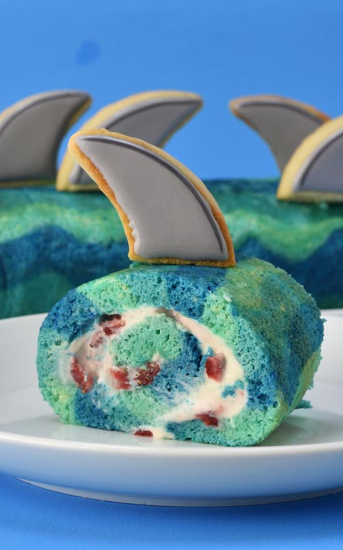 Slice of a cake roll on a plate.