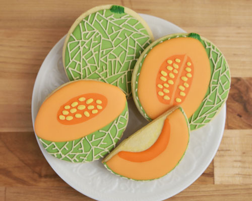 Cantaloupe sugar cookies on a plate.