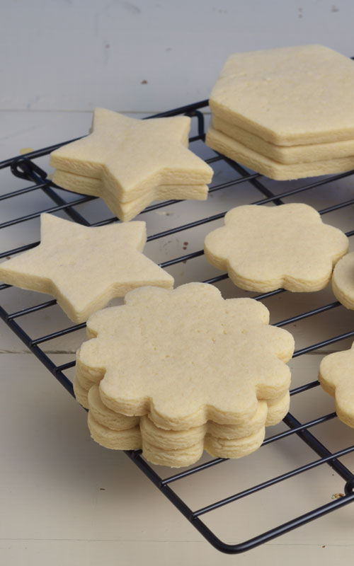 Flower cookies on a drying rack.