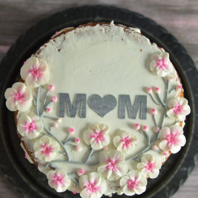 Mother's day cake decorated with buttercream cherry blossoms flowers.