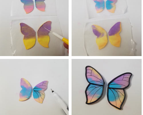 Drawing on royal icing butterflies with edible marker.