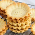 baked mini tart shells with on a cooling rack