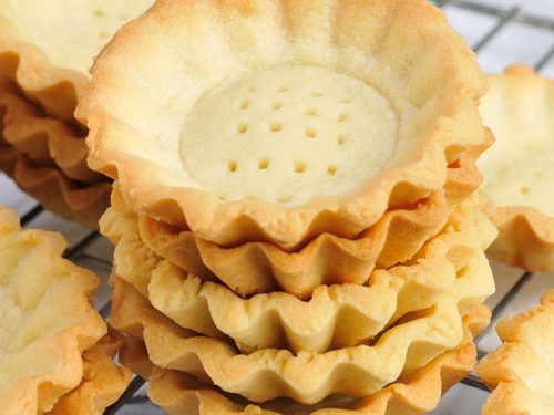 baked mini tart shells with on a cooling rack