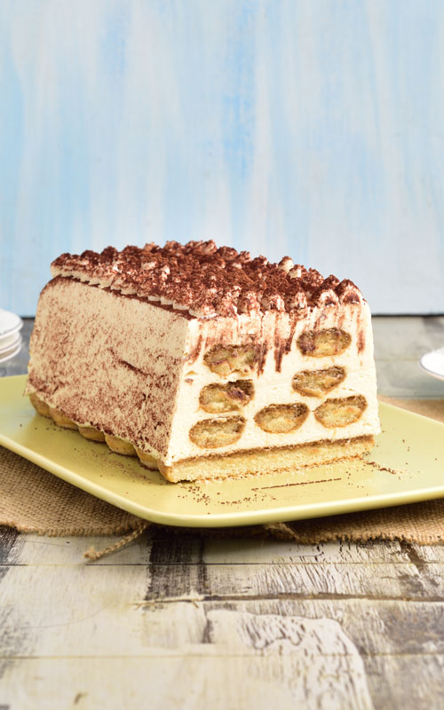 Baileys tiramisu cut on a serving dish.